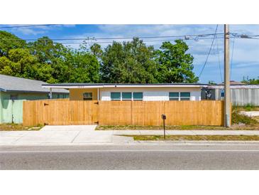 Charming single-story home featuring a well-maintained lawn and a classic wood fence enhancing curb appeal at 1009 S Ivey Ln, Orlando, FL 32811