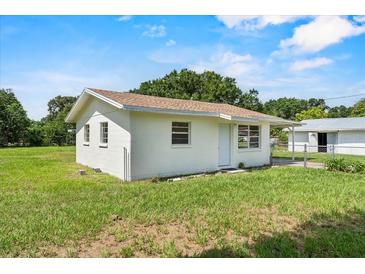 Charming single-story home featuring a well-maintained lawn and a simple, classic design at 120 & 0 8Th Wahneta W St, Winter Haven, FL 33880