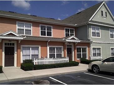 Multi-story townhome featuring an attractive color scheme, front porch, and well-maintained landscaping at 2219 San Vittorino Cir # 106, Kissimmee, FL 34741