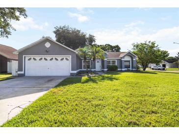 Charming single Gathering home with a manicured lawn and a two car garage at 4215 Red Bird Ave, St Cloud, FL 34772