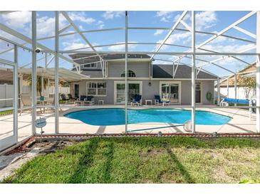 Screened-in pool with sunbathing chairs, outdoor furniture, and a lovely view of the home at 108 Honeywood Ct, Kissimmee, FL 34743