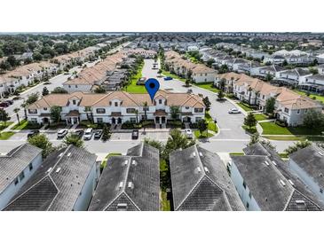Community aerial view showcasing the well-maintained townhomes with tiled roofs and lush landscaping at 1578 Slice Way, Davenport, FL 33896