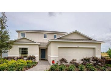 Charming two-story home with a two car garage, landscaped yard and welcoming front entrance at 5225 Tuscany Ln, Davenport, FL 33897