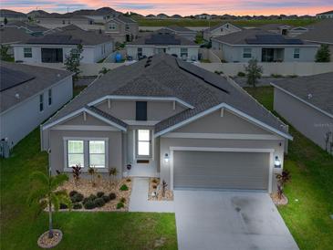 Charming single-Gathering home featuring a well-manicured lawn, two-car garage, and welcoming front entrance at 757 Citrus Reserve Blvd, Davenport, FL 33837