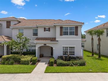 Charming two-story home with lush landscaping and a welcoming front porch at 8947 Stinger Dr, Davenport, FL 33896