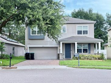 Charming two-story home boasts a two-car garage, covered porch, and well-maintained landscaping at 2813 Roseglen Way, Orlando, FL 32812