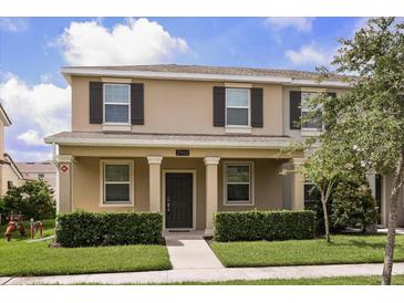 Charming two-story home with a cozy front porch, complemented by manicured landscaping and a welcoming entrance at 2966 Aqua Virgo Loop # 16, Orlando, FL 32837