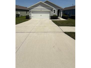 Charming single-story home featuring a spacious driveway and a well-maintained lawn at 30346 Armenia Rd, Leesburg, FL 34748