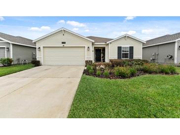 Charming single story home featuring an attached two car garage and well maintained front yard at 4338 Finch Ln, Kissimmee, FL 34746