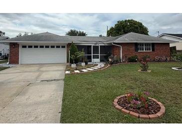 Charming single-story brick home with a well-manicured lawn and a two-car garage at 2013 Marilyn Ave, Winter Haven, FL 33881