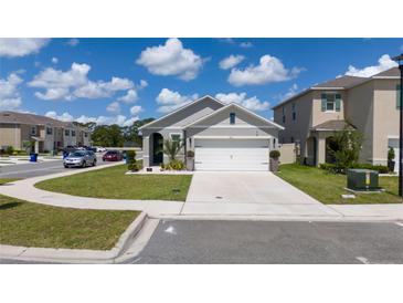 Charming single-Gathering home with a well-maintained lawn, attached two-car garage and neutral color palette at 2211 Tay Wes Dr, St Cloud, FL 34771