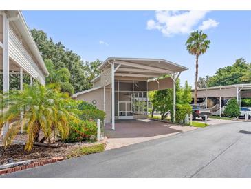 Charming home featuring a covered entrance, lush landscaping, and brick paved driveway and walkway to the front door at 2343 St George Dr, Davenport, FL 33837