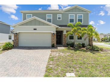Charming two-story home featuring a two-car garage, brick accents, and freshly manicured front yard at 2759 Slash Way, St Cloud, FL 34771