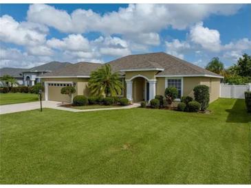 Charming single-story home with an arched entryway and meticulously manicured lawn at 301 Terranova Blvd, Winter Haven, FL 33884