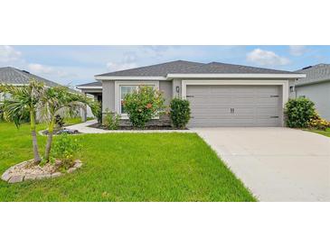 Beautiful single Gathering home featuring a well maintained lawn and a two car garage at 4505 Hummingbird Ln, Haines City, FL 33844