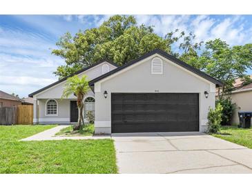 Charming single Gathering home with a well-manicured lawn and a two-car garage at 946 Little Creek Rd, Orlando, FL 32825