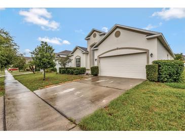 A beautiful single-Gathering home featuring a two-car garage and well-manicured landscaping at 954 Revere Ave, Haines City, FL 33844