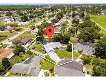Overhead view of a single Gathering home on a large lot with a private screened-in pool and fenced backyard at 113 Candlewood Ct, Kissimmee, FL 34743
