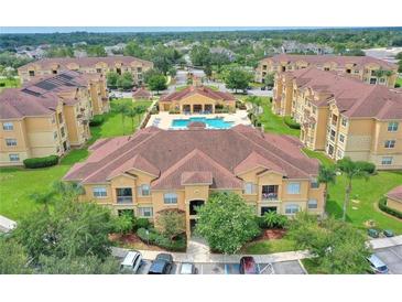 An aerial view of a residential community featuring a pool and manicured grounds at 504 Terrace Ridge # 311, Davenport, FL 33896