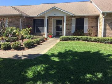 Charming single-story brick home featuring a well-manicured lawn and colorful landscaping, offering great curb appeal at 904 Michigan Ave, St Cloud, FL 34769