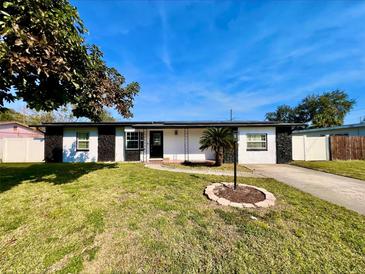 Charming single-story home with well-maintained lawn, crisp white paint and modern black trim at 1211 Lehigh St, Kissimmee, FL 34744