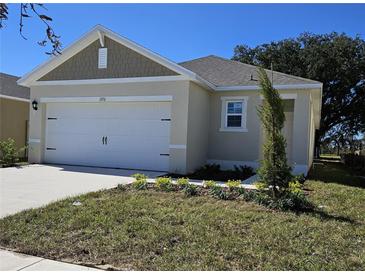 Charming single-Gathering home with a two-car garage and well-manicured lawn at 1370 Holodak Dr, Davenport, FL 33837