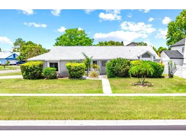 Charming single-story home featuring lush landscaping and a well-manicured lawn at 2637 Debany Rd, Kissimmee, FL 34744