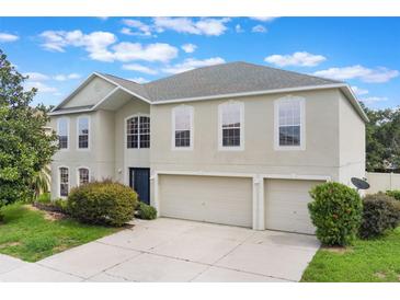 Charming two-story home with a spacious three-car garage and beautifully landscaped front yard at 364 Fish Hawk Dr, Winter Haven, FL 33884