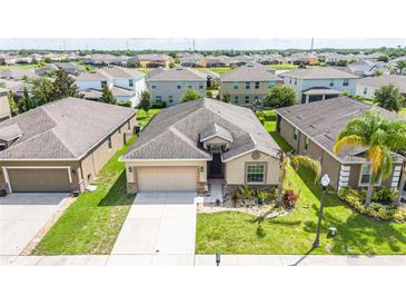 Lovely single Gathering home featuring a well-manicured lawn, two-car garage, and neutral color palette at 4928 Cortland Dr, Davenport, FL 33837