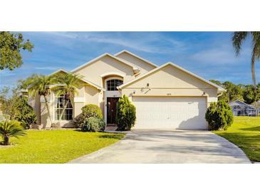 Charming single Gathering home featuring a two-car garage and well-manicured lawn at 1014 Prey Ct, Kissimmee, FL 34746