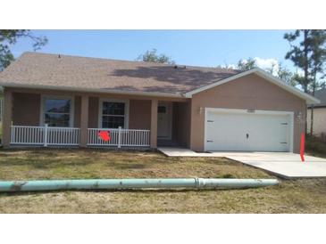 Charming single-story home with a well-maintained lawn, cozy front porch, and an attached two-car garage at 110 Sparrow Ct # 9, Kissimmee, FL 34759