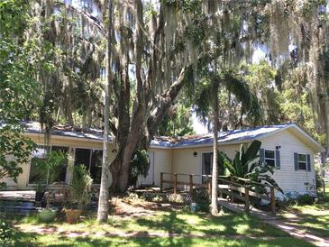Charming single-story home with a ramp, mature trees, and lush landscaping provides a serene setting at 5019 Pineapple St, Lake Wales, FL 33898