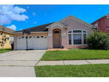 Charming single-story home with a two-car garage and well-maintained lawn at 1730 Sir John Ct, Orlando, FL 32837
