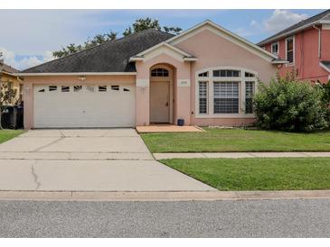Charming single-story home featuring a well-manicured lawn and a two-car garage at 1730 Sir John Ct, Orlando, FL 32837