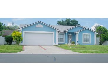 Charming one-story home featuring a well-maintained lawn and an attached two-car garage at 2773 Woodstream Cir, Kissimmee, FL 34743