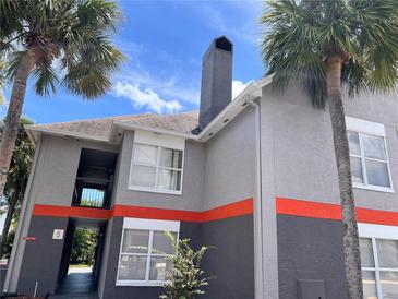 Modern two-story exterior elevation featuring palm trees and gray toned stucco at 3100 Parkway Blvd # 521, Kissimmee, FL 34747
