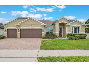 Charming, single-story home featuring a two-car garage and lush landscaping at 3212 Preserve Dr, Orlando, FL 32824
