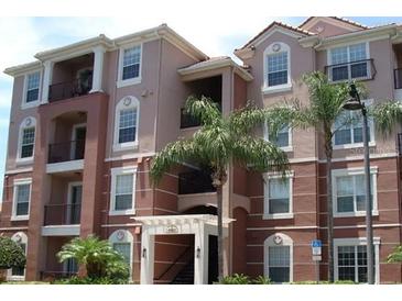 Attractive multi-story condo building with well-maintained facade and tropical landscaping at 4862 Cayview Ave # 40409, Orlando, FL 32819