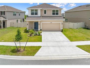 Charming two-story home featuring a two-car garage, well-maintained lawn, and inviting curb appeal at 7413 Bent Tree Loop, St Cloud, FL 34771