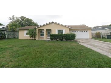 Charming single-story home with a well-maintained lawn and a two-car garage at 956 Florida Pkwy, Kissimmee, FL 34743