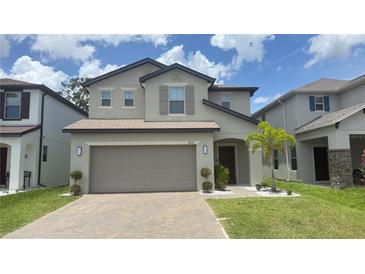 Charming two-story home with a two-car garage and a well-manicured lawn at 2833 Noble Crow Dr, Kissimmee, FL 34744