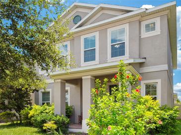 Charming two-story home with well-maintained landscaping and a welcoming front porch at 7266 Desert Mandarin St, Winter Garden, FL 34787