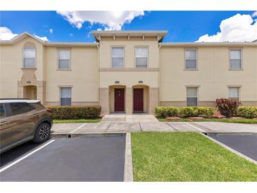Inviting townhome with manicured landscaping, neutral paint, and convenient parking at 2855 Club Cortile Cir, Kissimmee, FL 34746