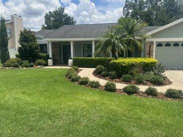 Charming single-story home with a well-manicured lawn and lush landscaping at 3715 Sarasota Ct, Orlando, FL 32812