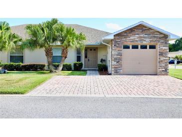 Charming home with stone accents, desert landscaping, brick paver driveway, and a two-car garage at 1749 Christina Lee Ln, St Cloud, FL 34769