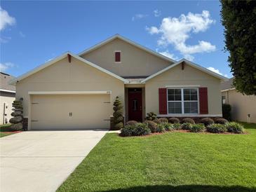 Charming single-Gathering home featuring a well-manicured lawn and tasteful landscaping at 306 Briar Patch Loop, Davenport, FL 33896
