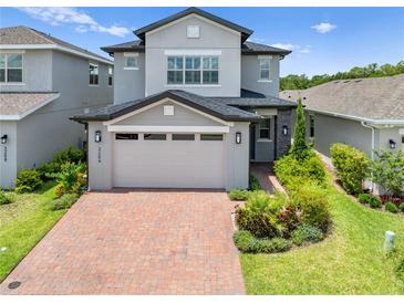 Charming two-story home with brick driveway and landscaped front yard creates instant curb appeal at 3204 Oxbow Ct, St Cloud, FL 34773