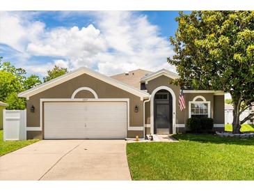 Charming single Gathering home with a well manicured lawn and a two car garage at 3217 Whooping Crane Run, Kissimmee, FL 34741
