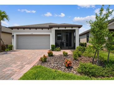 Charming single-story home with a screened porch, paver driveway, and well-maintained landscaping at 1309 Lombardi Ct, Kissimmee, FL 34759