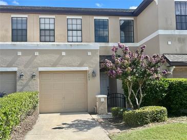 Charming townhouse with a well-manicured lawn and a one-car garage at 2243 Seven Oaks Dr, St Cloud, FL 34772